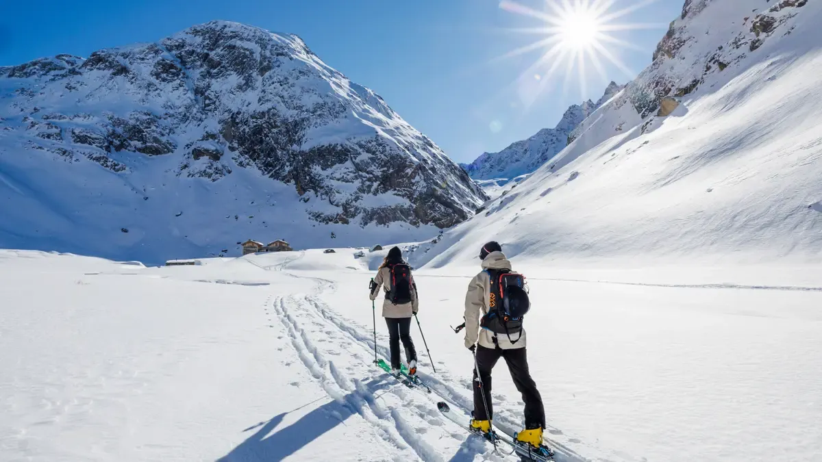 A couple skiing together in meribel